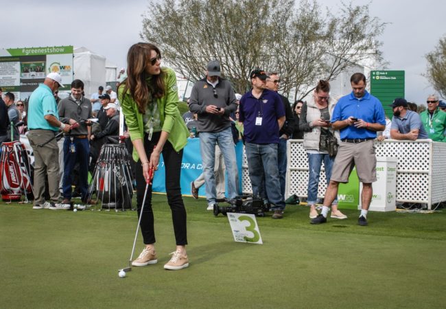 Celebrity putting challenge participant golfing